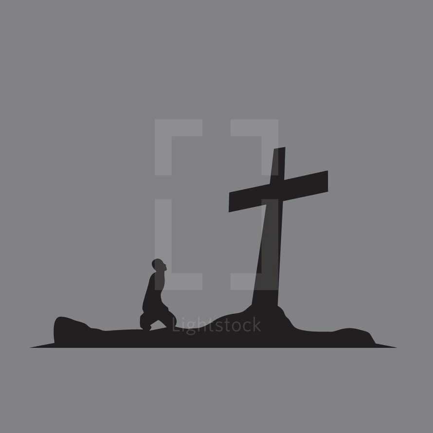 man kneeling looking up at a cross 