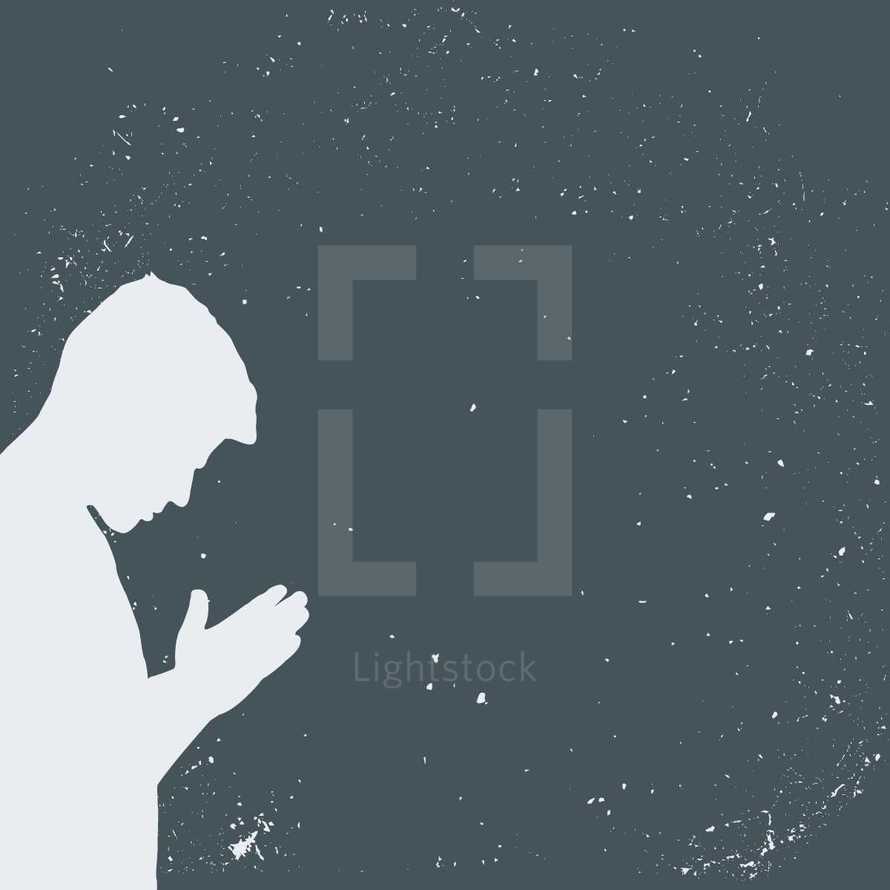 grunge silhouette of a man in prayer.