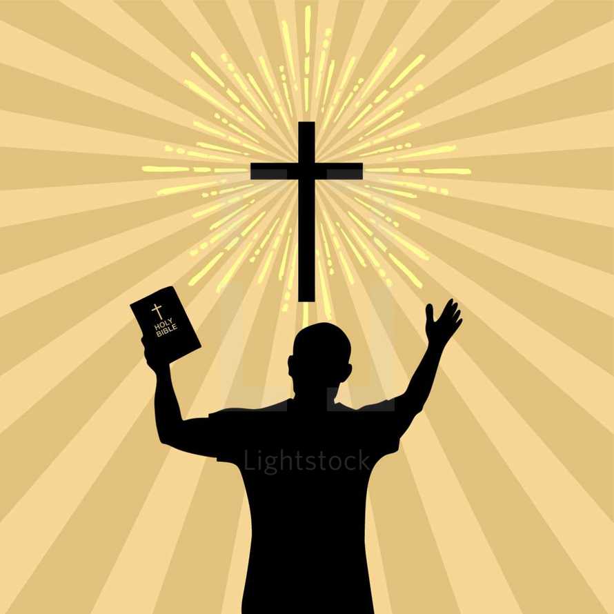 man holding a Bible with raised hands 