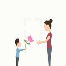 child giving a flower to his mother